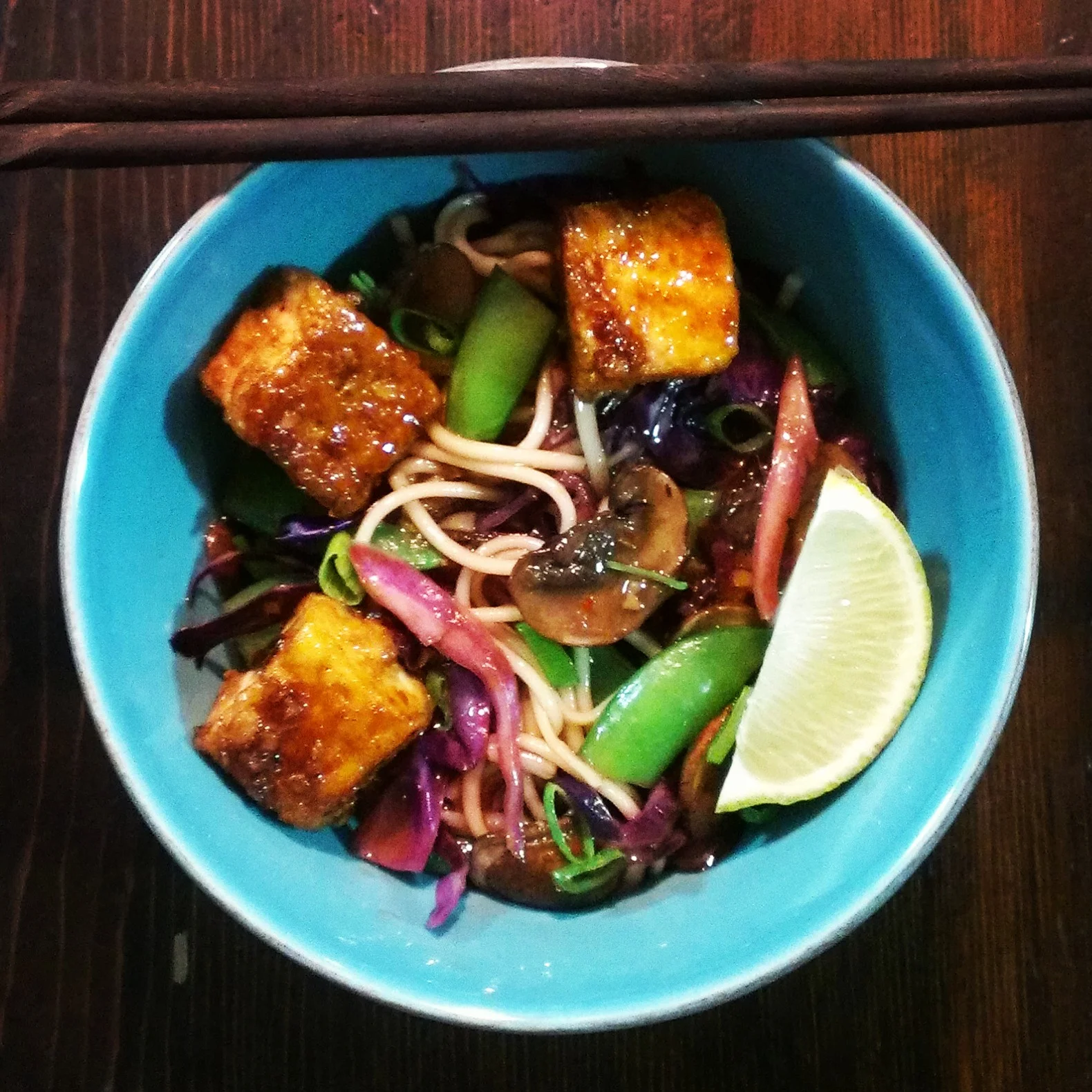 kung pao tofu, fried udon noodles, cabbage, snap peas, mushrooms