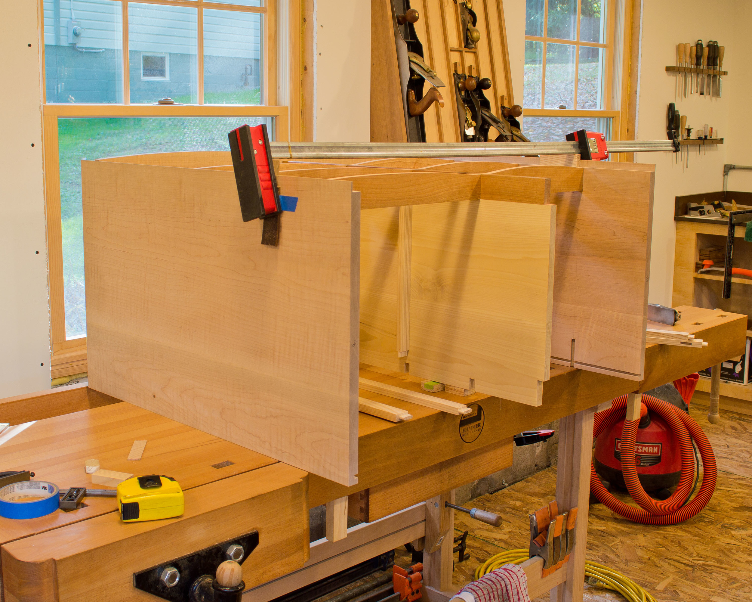  Assembling the horizontal dividers to the sides/vertical divider. &nbsp;The horizontal divider is half-lapped at the vertical divider and has a dovetail tenon on each end that fits into dovetail mortises in the case sides. 