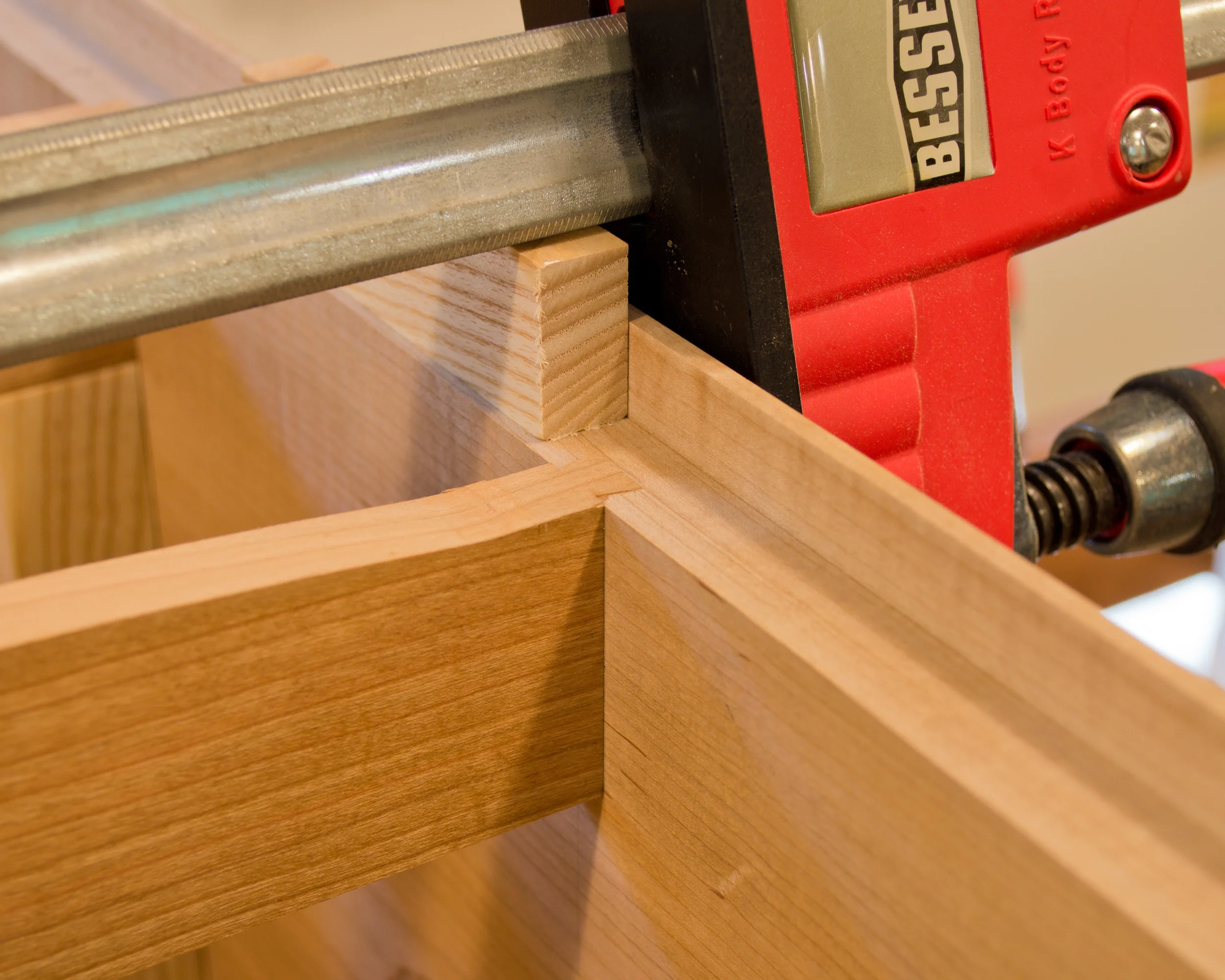  A little tough to make out, but you can kind of see the dovetail tenon on the end of the cherry horizontal divider (which has been inserted in the dovetail mortise on the case side). &nbsp;There you have it, a sliding dovetail. 