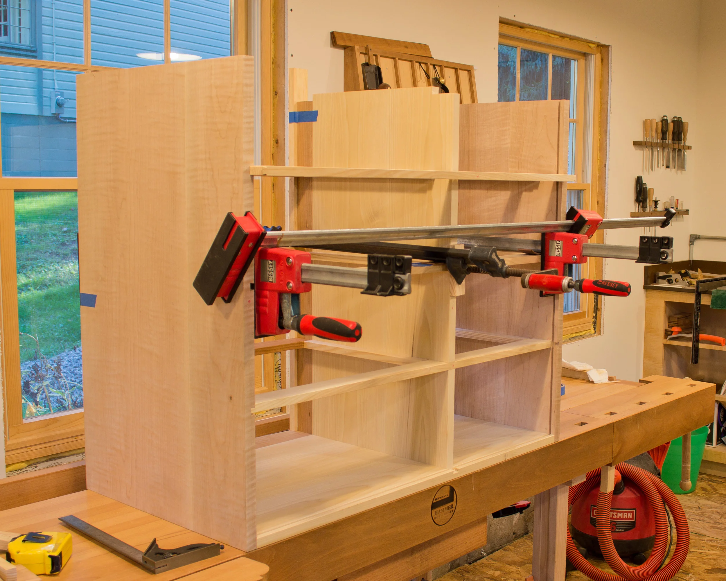 I'm using clamps to pull one of the rear horizontal dividers into position. Again, sliding dovetails and half laps.