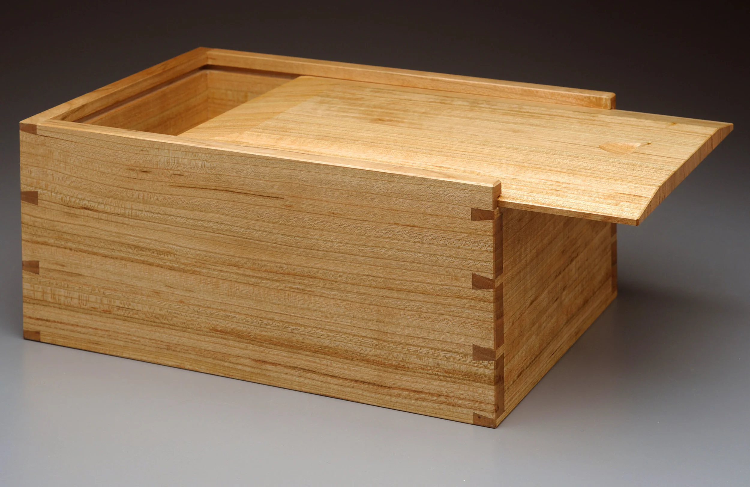 Jen's Keepsake Box Inspired by candle boxes made by the Shakers, this keepsake box is made of quartersawn cherry, with a white pine bottom. The through dovetails are hand-cut, and the sliding lid is shaped by hand. The original, shown here, was a wedding gift for my wife. 7.5" W x 10.5" L x 5" D Photo by Charley Freiberg
