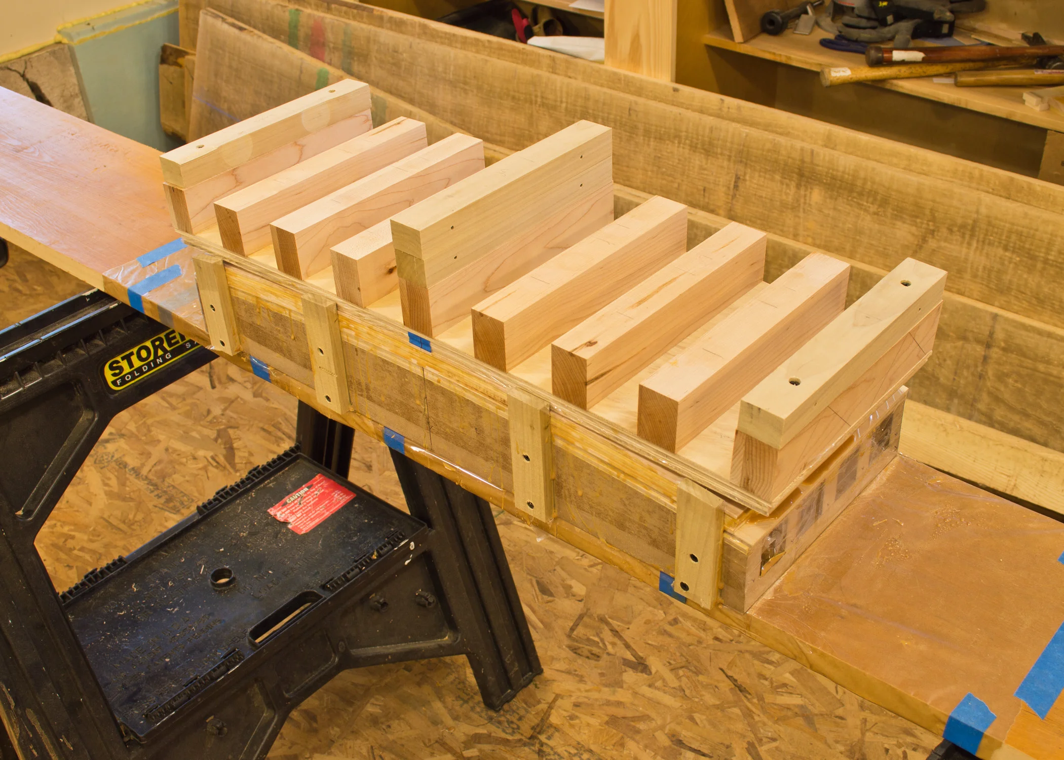 Clamps have been removed, showing the clamping cauls. Notice how the plywood cauls have sprung back from the form.