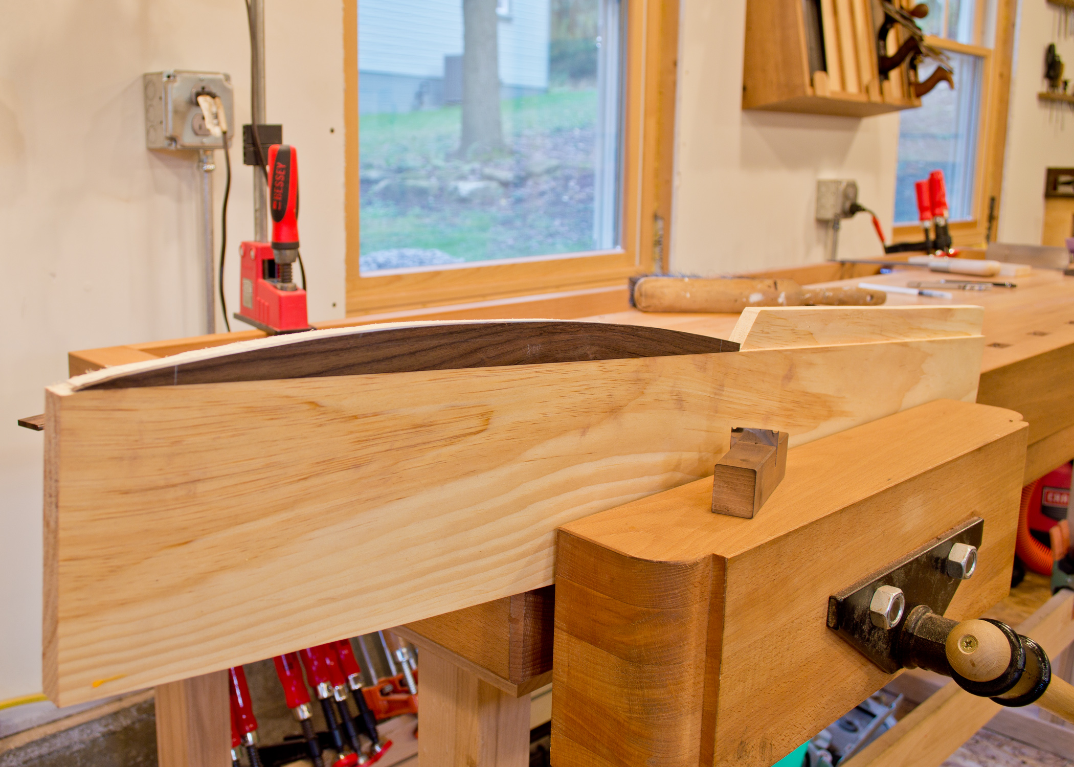  Sometimes the biggest challenge is holding the work. &nbsp;The rosewood bead stock is too small to hold comfortably. &nbsp;Temporarily held to the pine board with double sided tape, I can now clamp it in my vise and easily work the rosewood. 