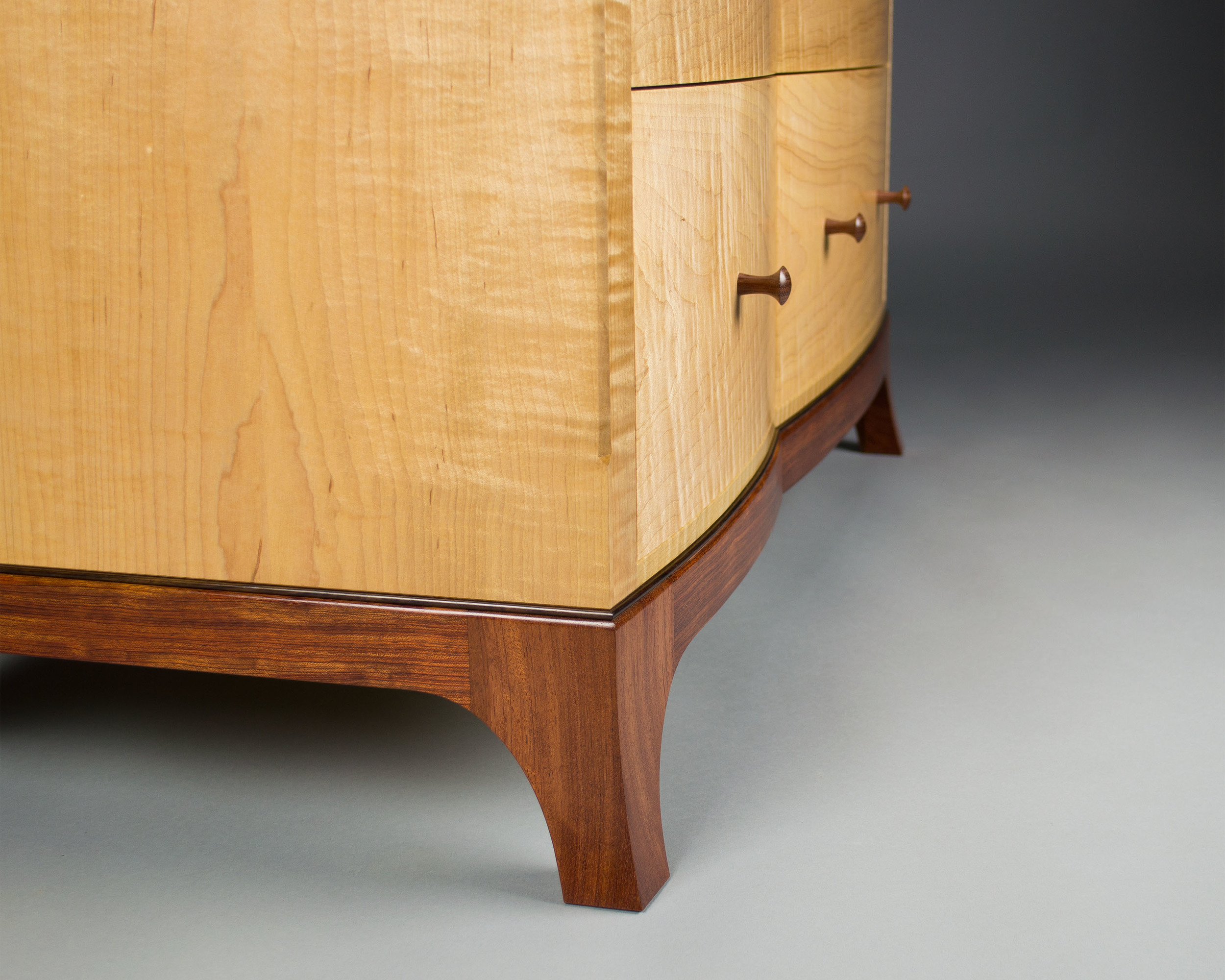  The bubinga and rosewood base is shaped to mirror the curves of the drawer fronts as well. 
