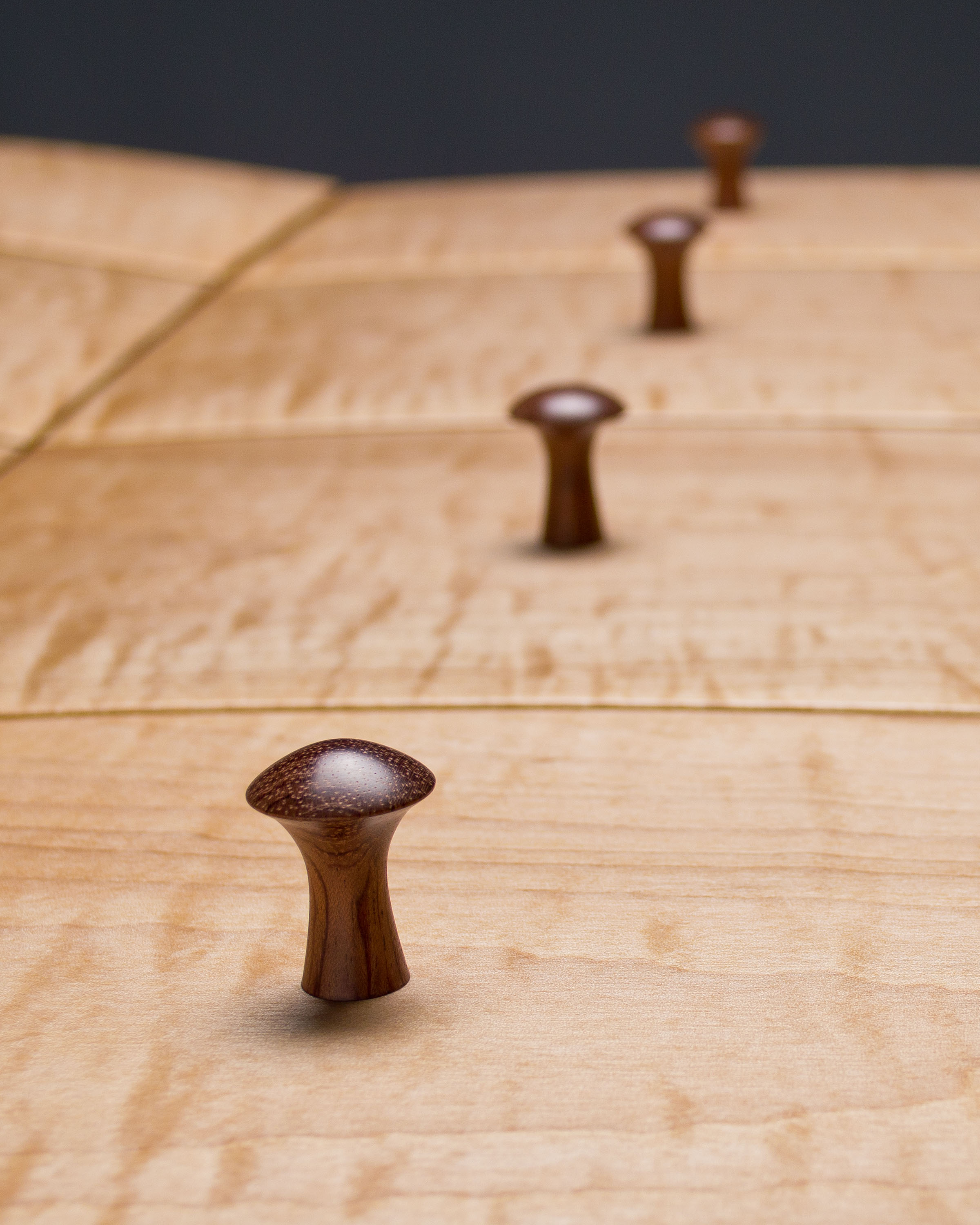  Bubinga was used for the turned knobs, which are secured to the drawer fronts with wedged through tenons. 