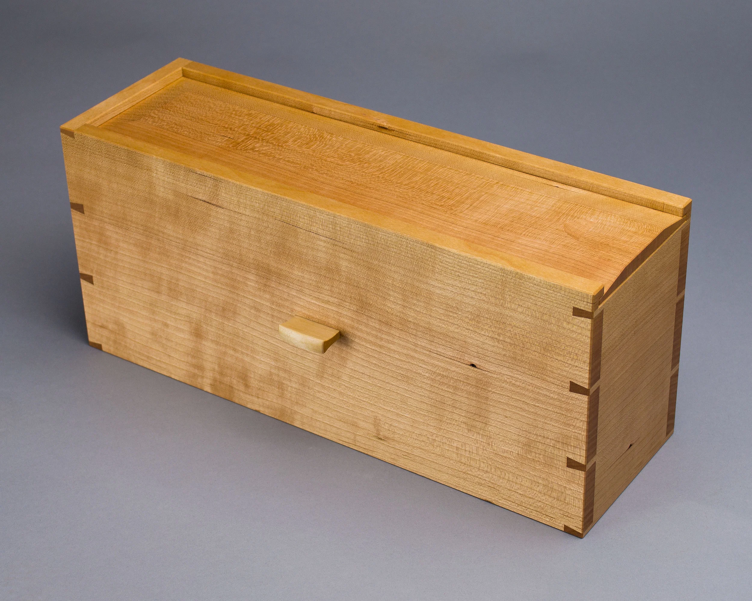 The hidden compartment, a dovetailed box made of quartersawn cherry.