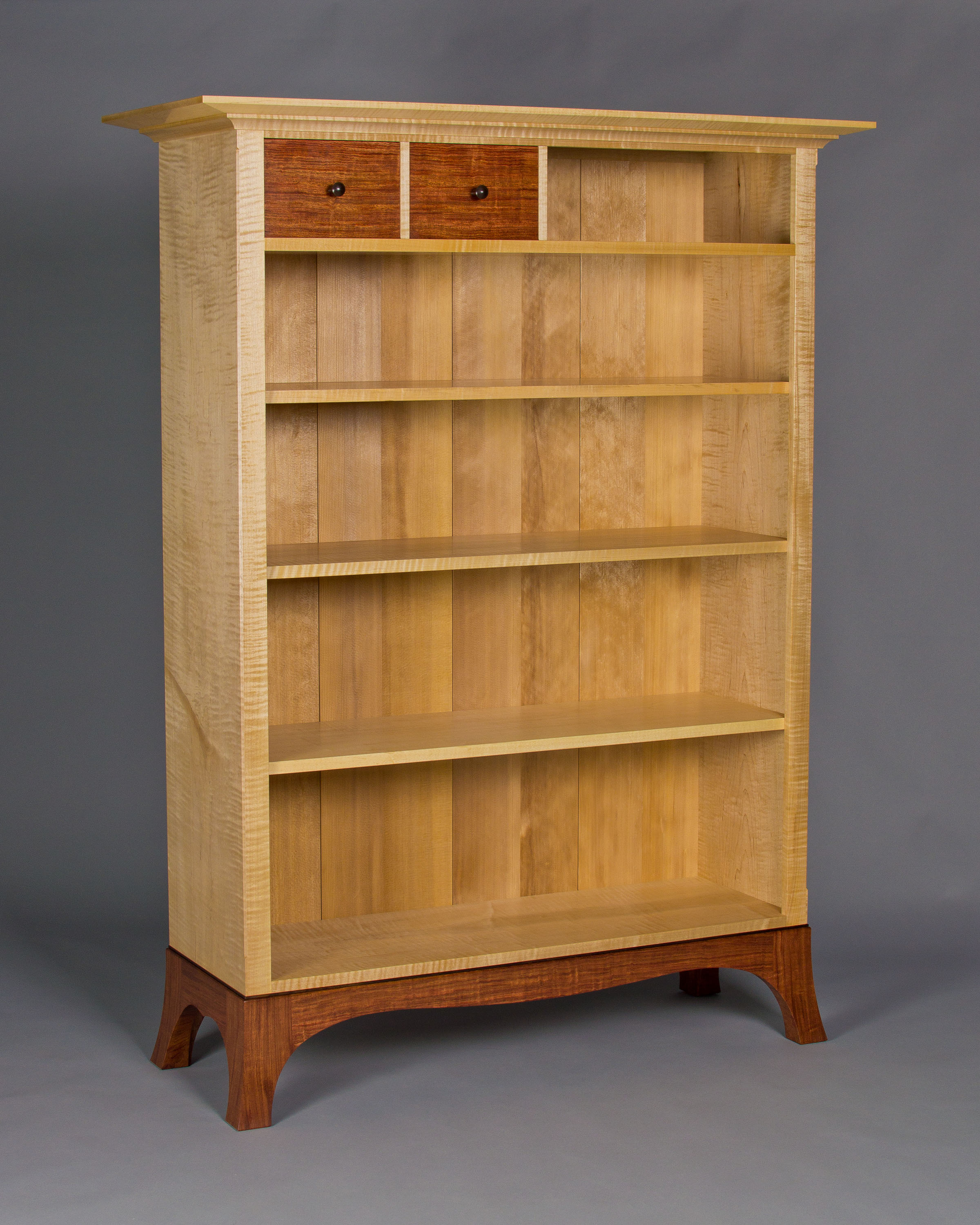 a custom designed bookcase with creative, asymmetric drawer arrangement
