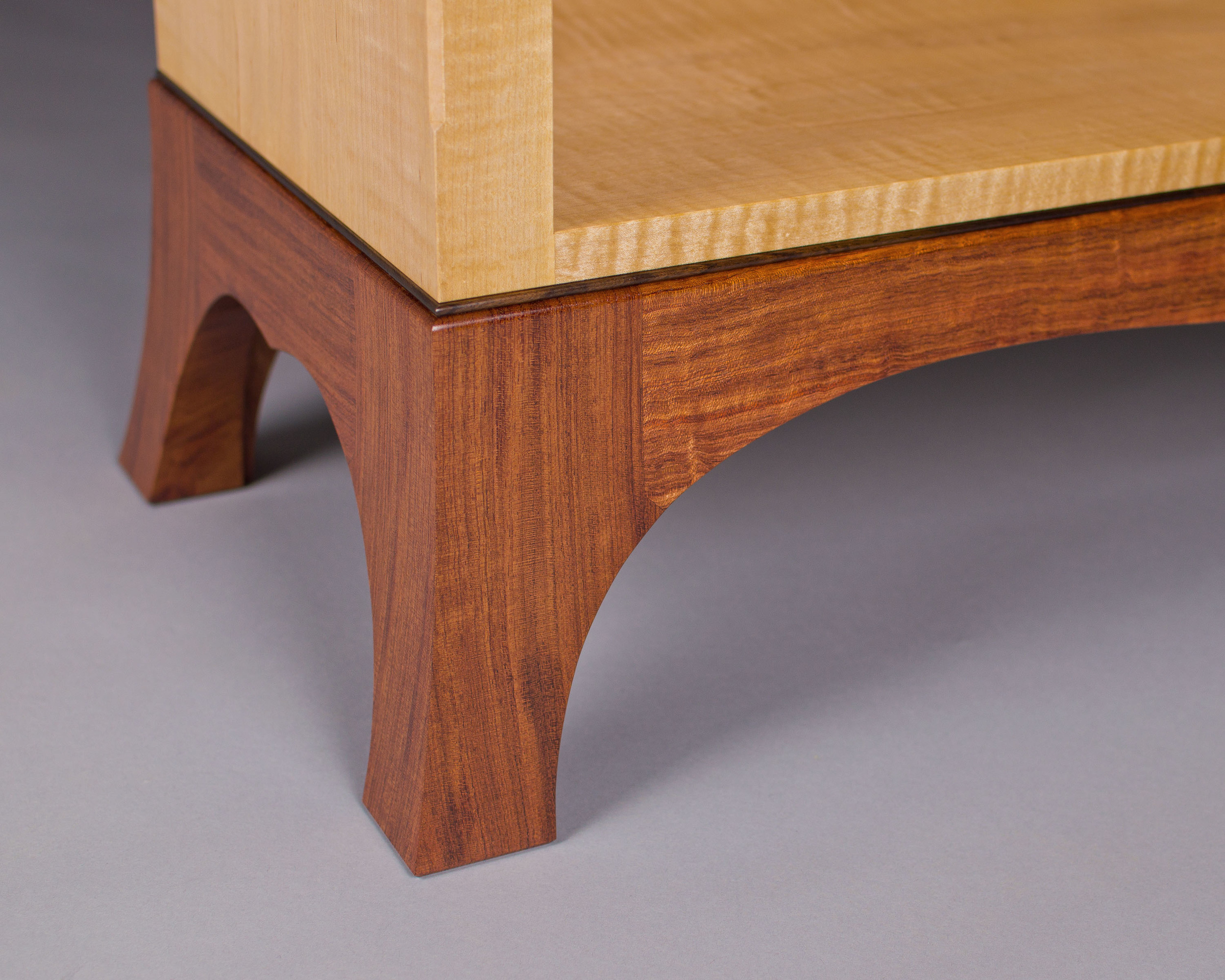 the base of the bookcase is finely detailed, with flared feet and a rosewood bead