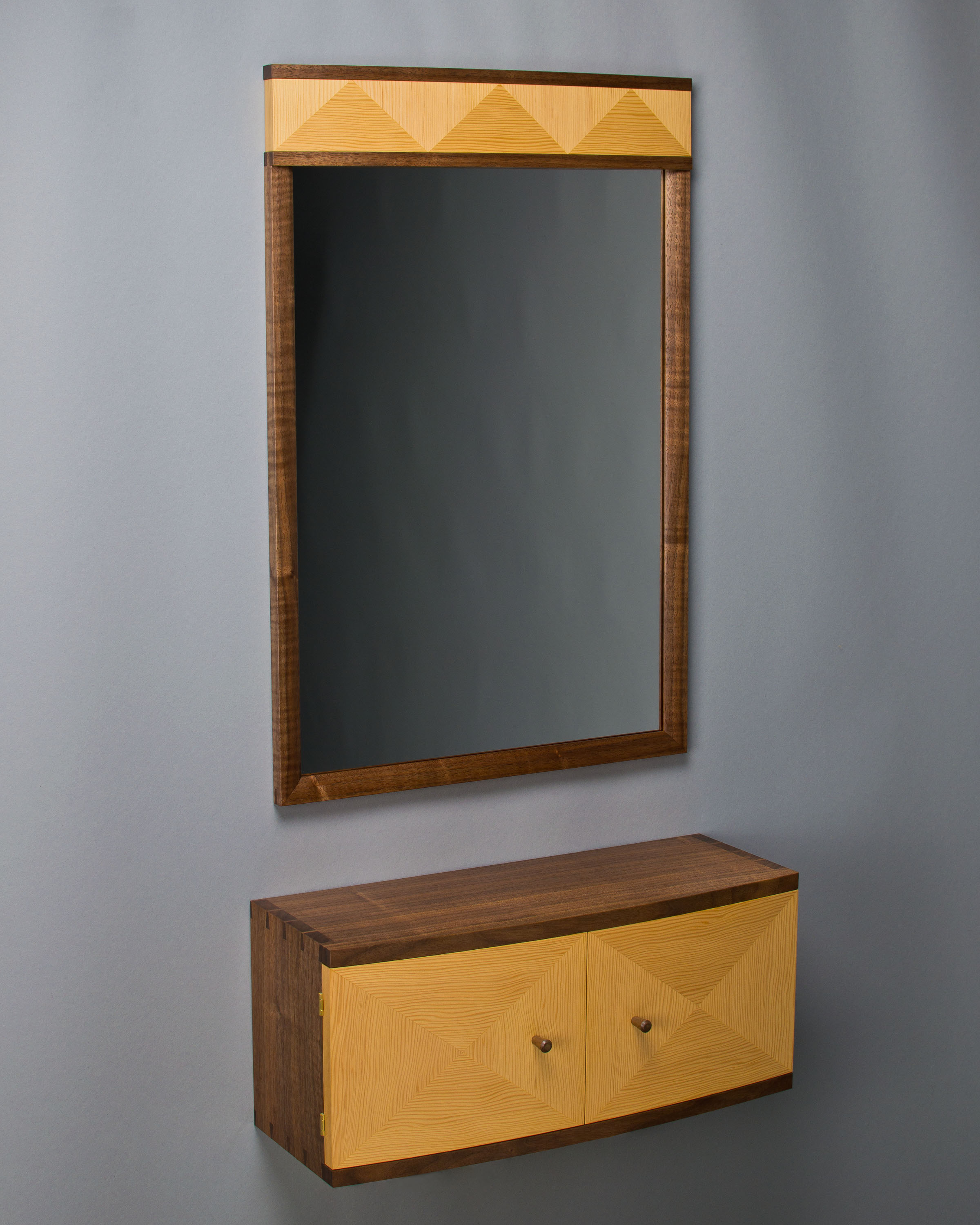 a mirror and wall cabinet made of black walnut and douglas-fir