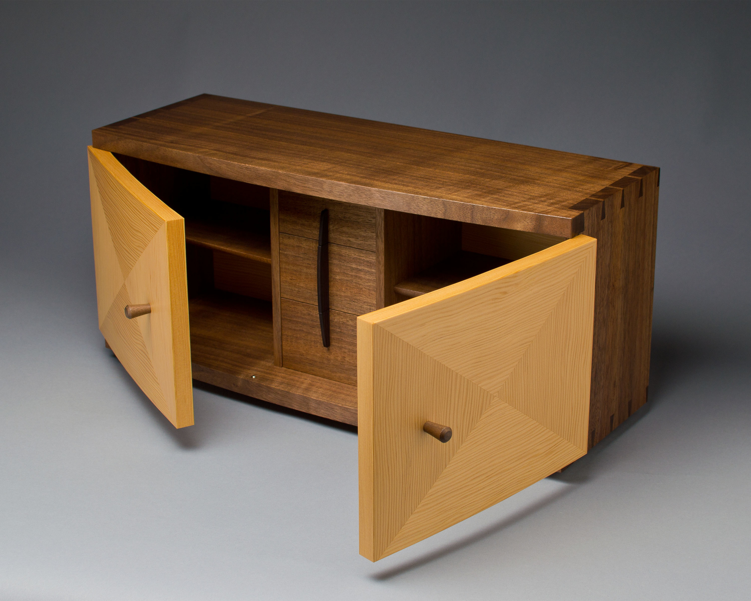 the doors of the cabinet are curved, made with laminations of douglas-fir veneer
