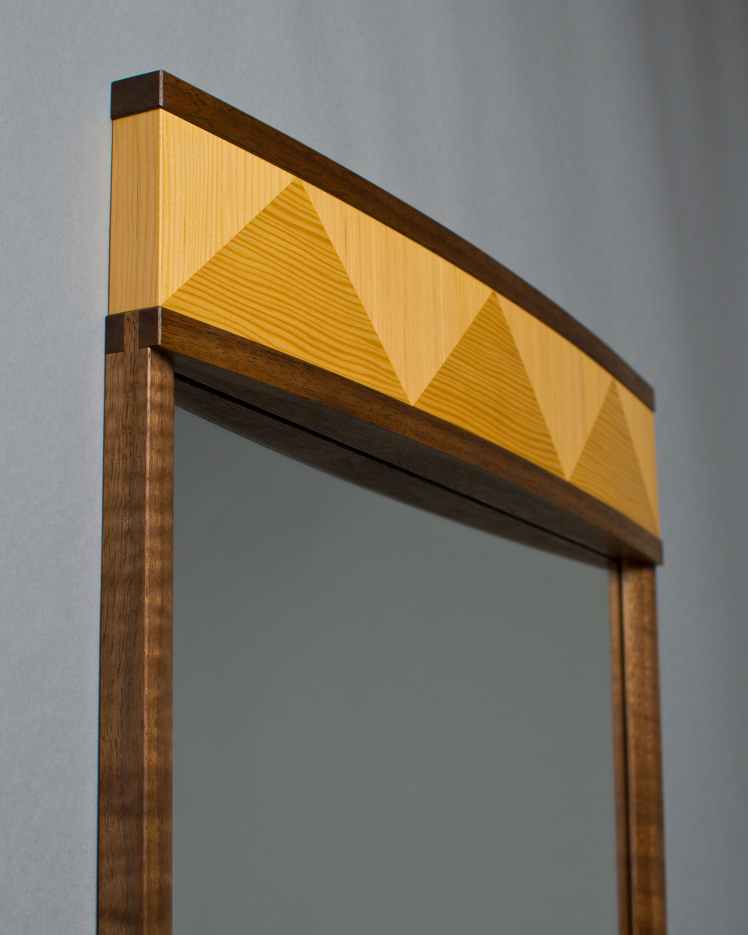 curved crown on top of mirror made of douglas-fir veneer