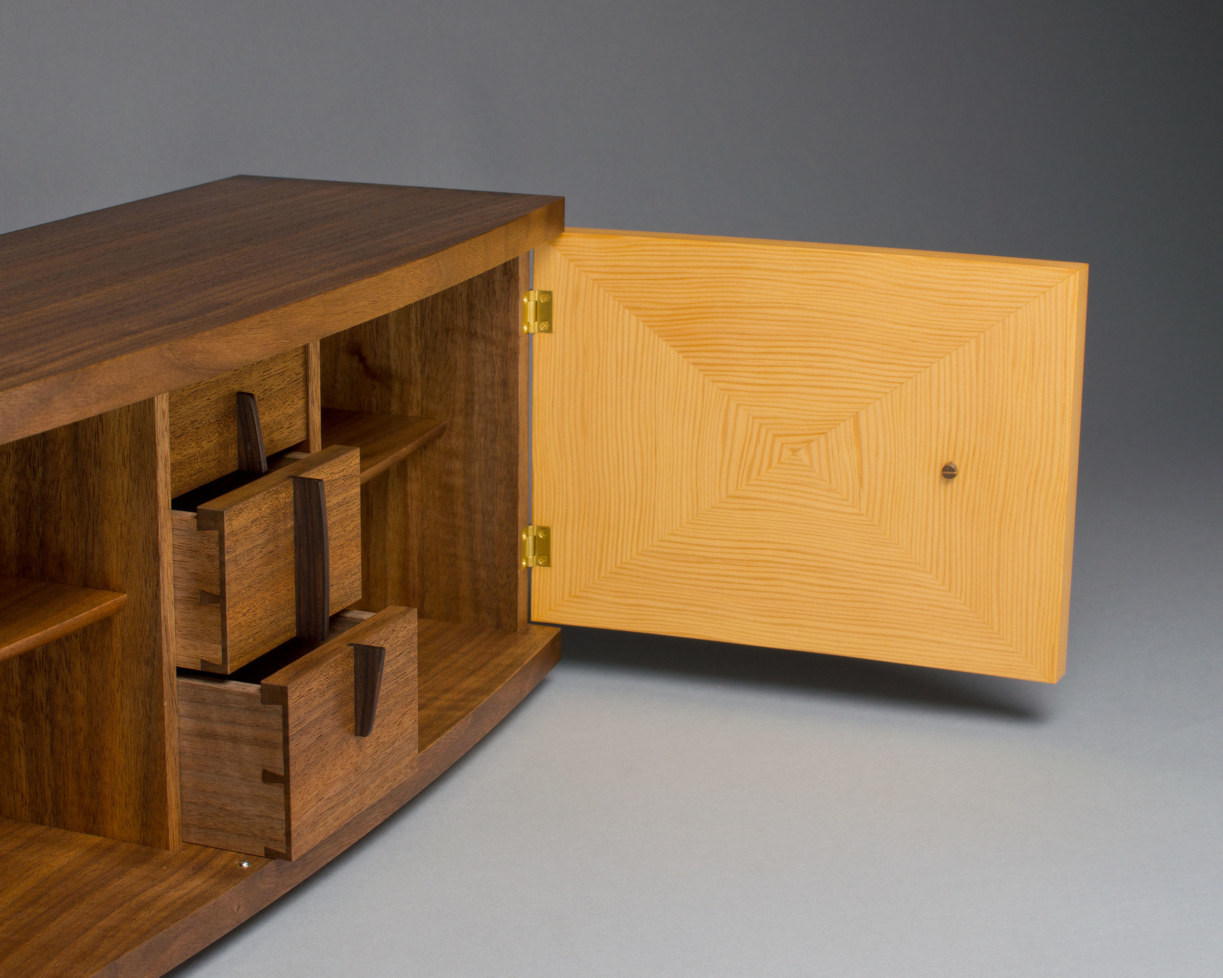 inside the cabinet is a column of three small dovetailed drawers