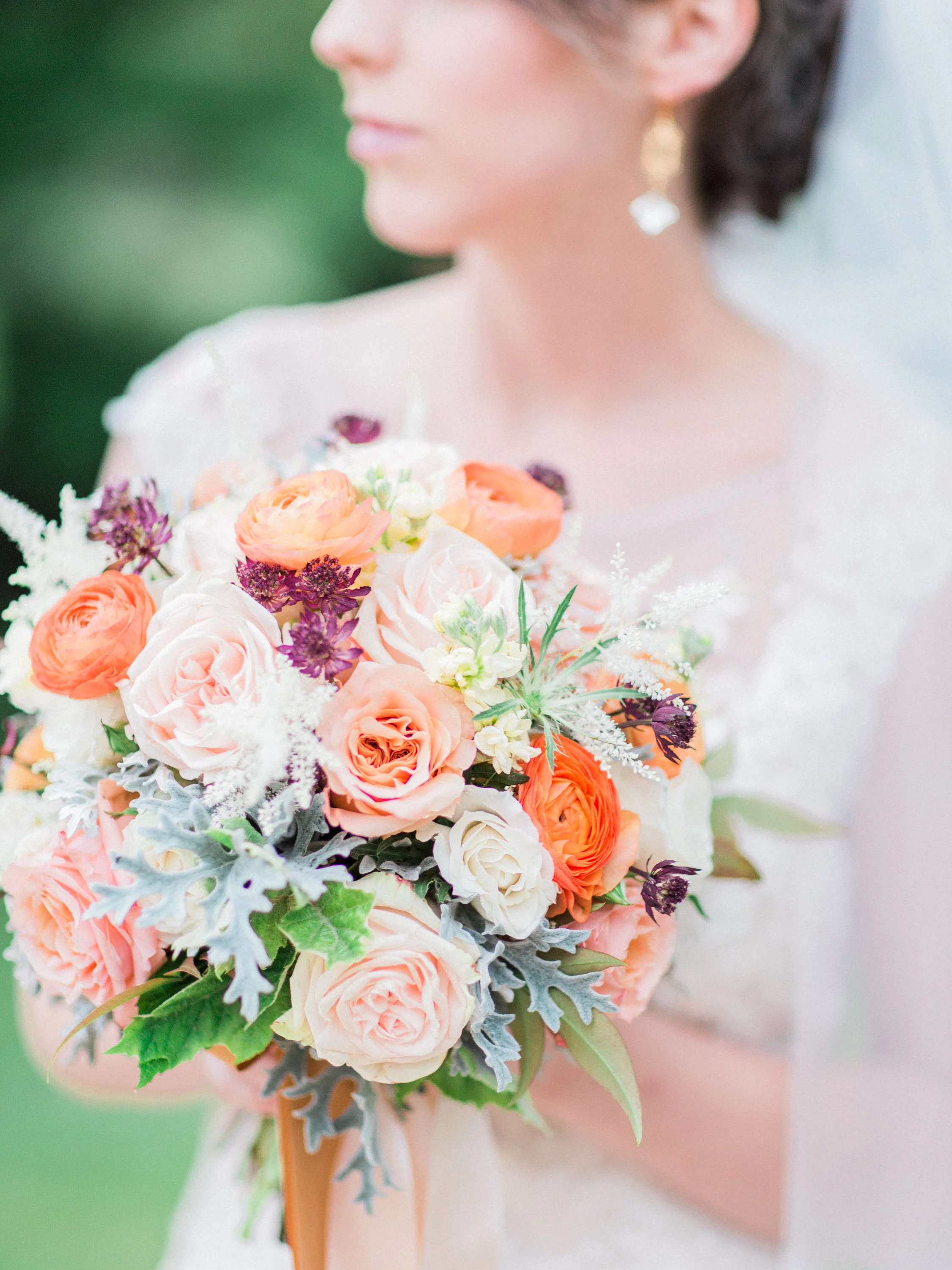 Bridal bouquet of peach Shimmer roses, orange ranunculus, purple astrantia by Lark Floral&nbsp;