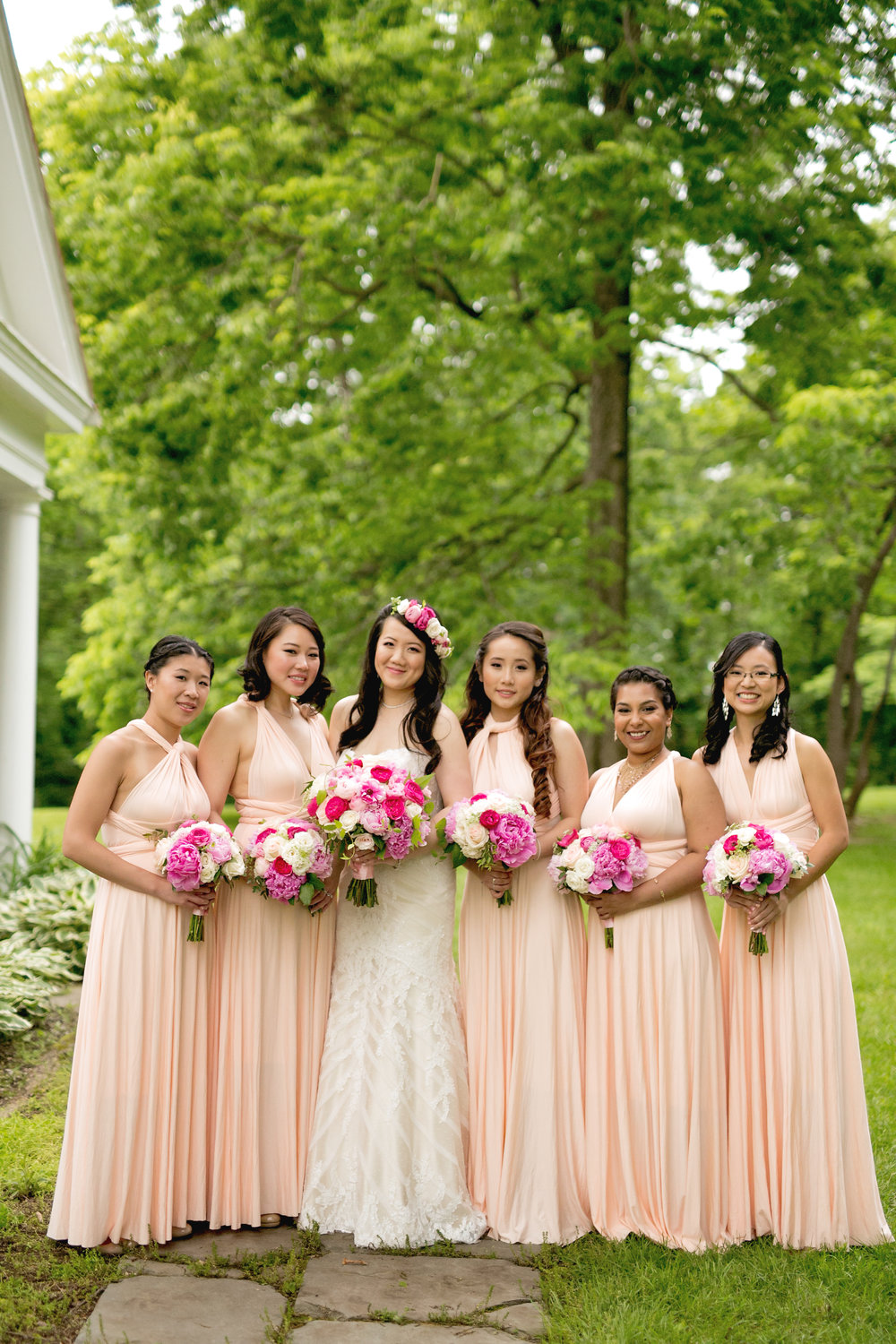 Bridesmaids with blush dresses and pink bouquets