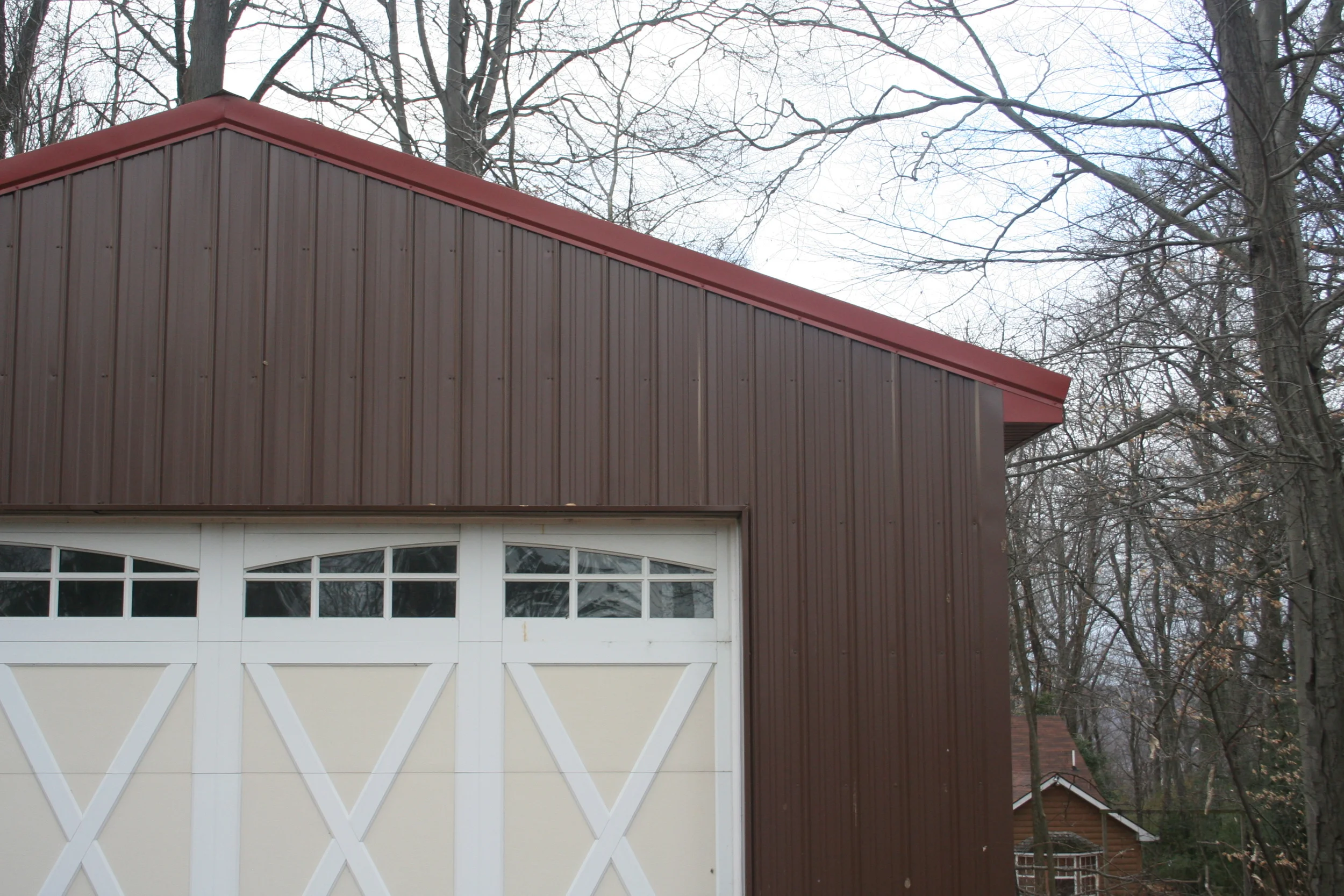 A close up of the new garage siding and door. 