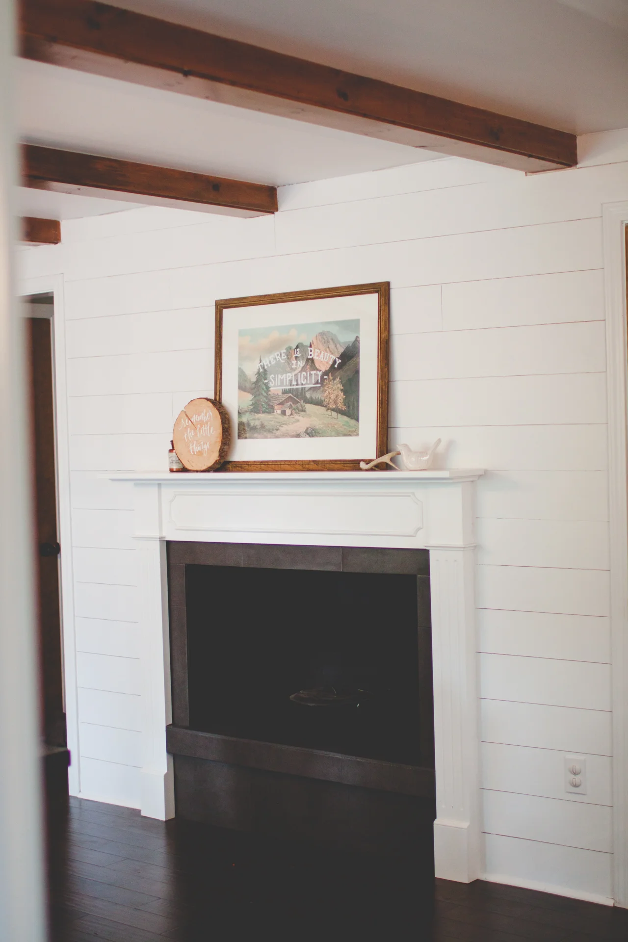 AFTER: New mantle, painted fireplace, new tile, shiplap, floors.