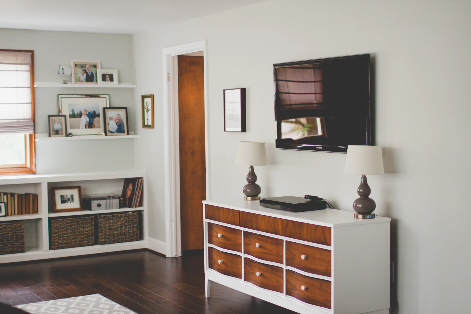 AFTER: Donald painted the entertainment center/dresser for me and I found the vintage knobs. Donald also mounted our tv with hidden cords using a little bit of pvc pipe and a total of probably $15; cords go into one of the bottom drawers through the back of the dresser. 