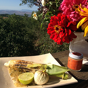 Diana's roasted corn in tomatillo, butter, a squeeze of lime and a sprinkle of Roxy Taco! 