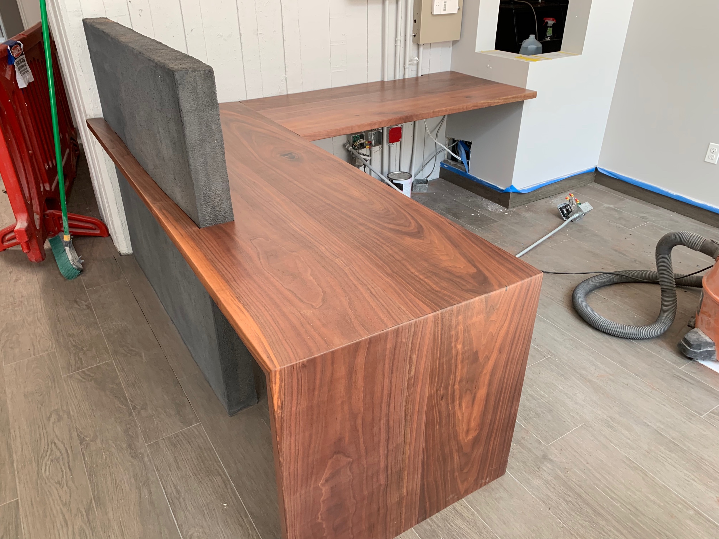 Walnut and concrete counter reception desk.