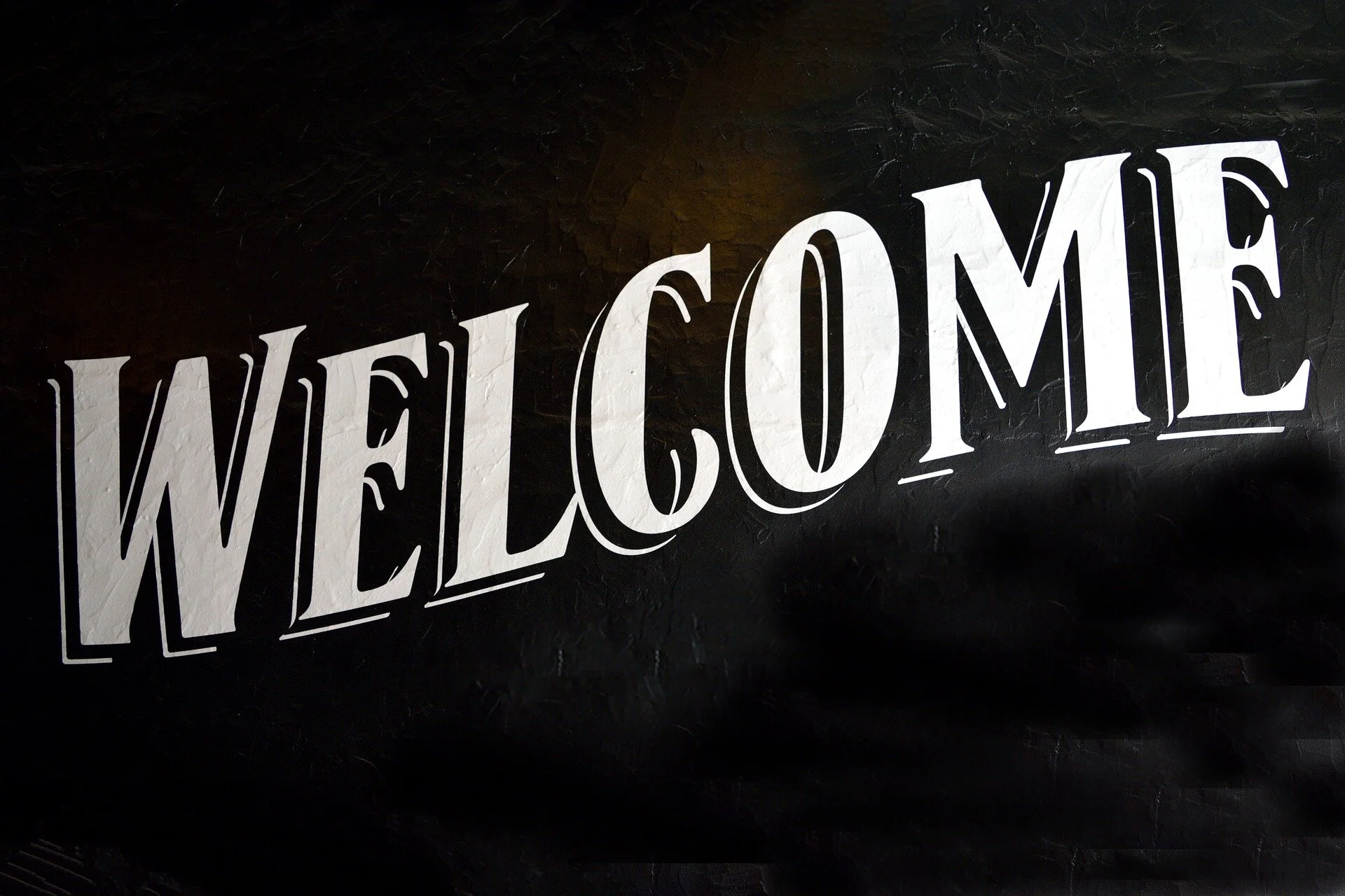 A black back drop with the word welcome on top.