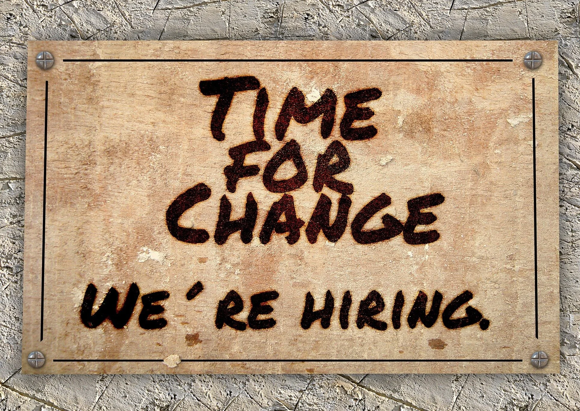 a wooden sign that reads, “Time for a change, we're hiring”