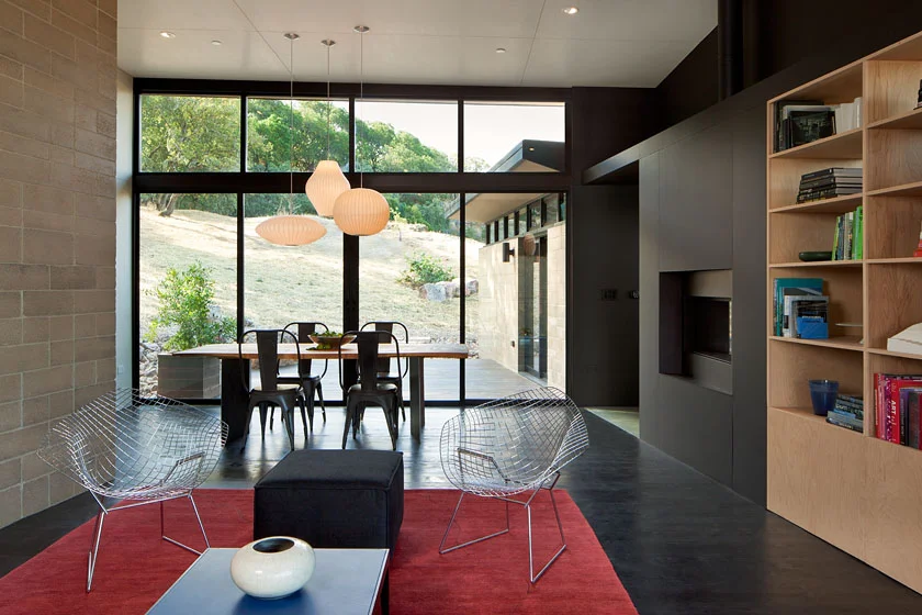 © Mark Luthringer Strategically placed windows puncture the masonry volumes to frame the landscape while maintaining privacy. Daylighting is incorporated and natural cross ventilation encouraged via a band of operable clerestory windows. Large sliding doors and decks promotes indoor / outdoor living on an otherwise challenging site.
