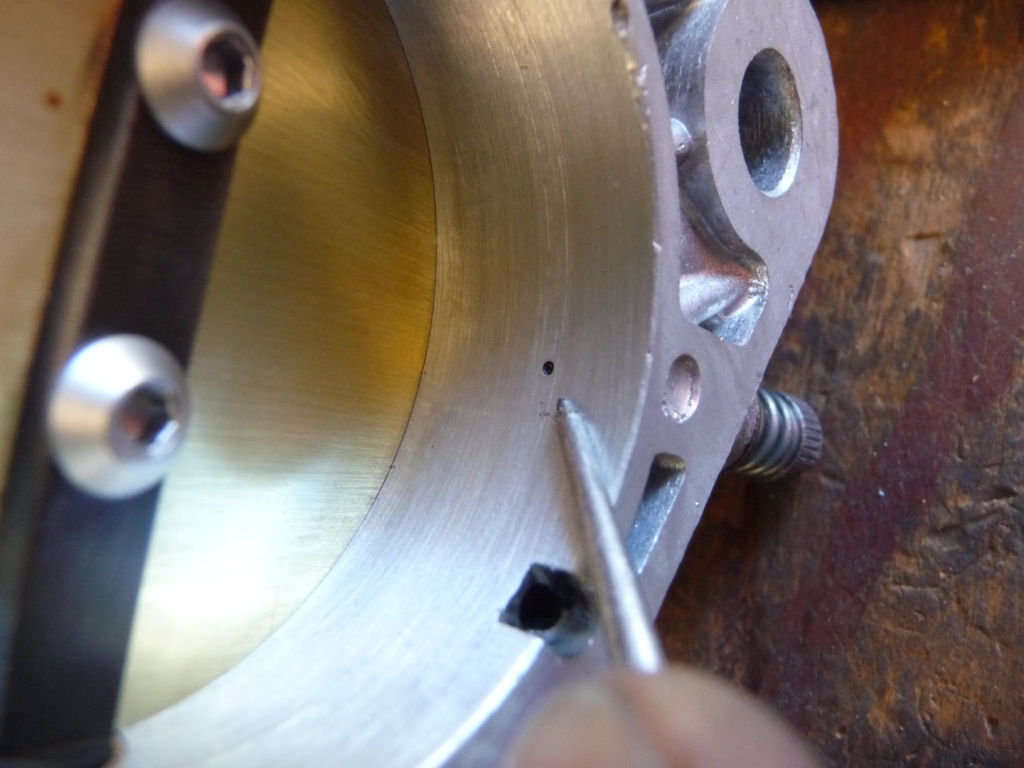 Weber 46IDA3C after idle adjustment showing first progression port blocked by edge of throttle plate and idle mixture screw hole open for allowing fuel flow.