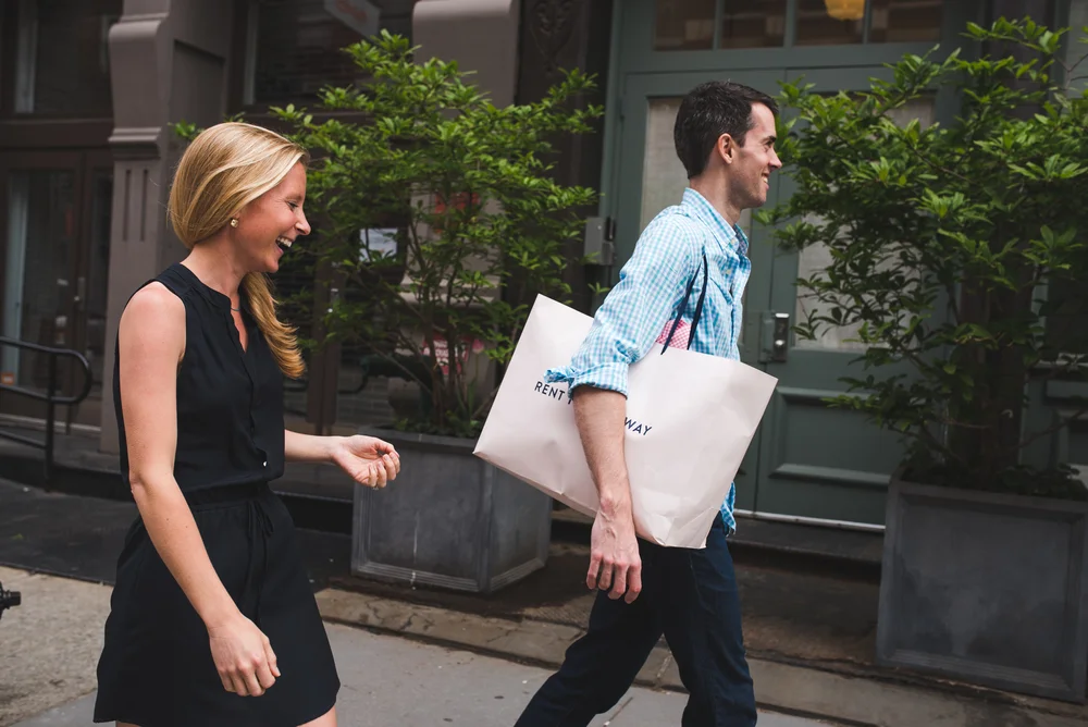 Candid engagement photo of a couple walking together through New York City