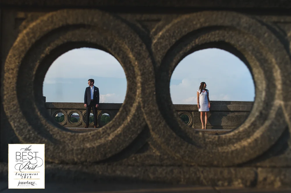 Engagement couple framed through stone arches