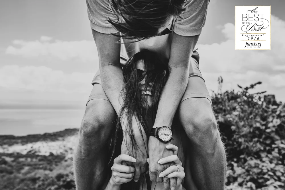 Black and white engagement portrait with wind and movement