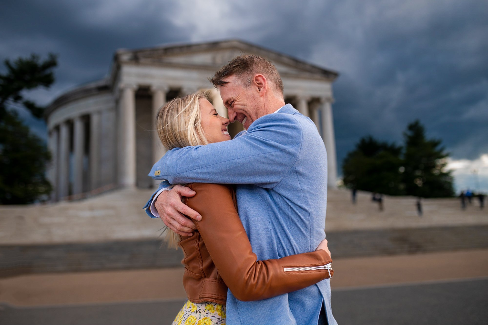 &lt;p&gt;A photo of a couple in a romantic embrace in front of the Jefferson Memorial in Washington D.C. The couple is standing on the marble steps leading up to the monument, which is illuminated by the warm light of the setting sun. The lush greene