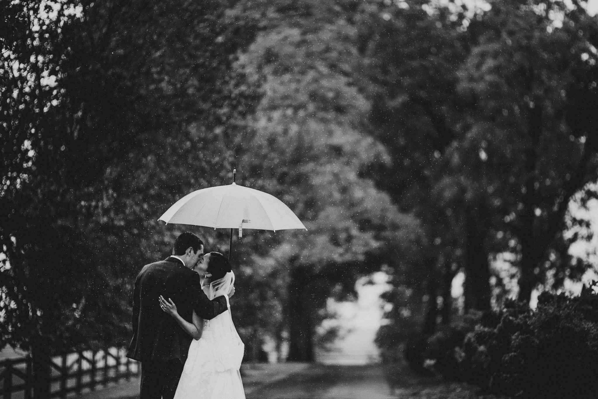 This magical moment between the newlyweds stopped me in my tracks. The rain may have been falling, but their love shone brighter. The black-and-white tones capture the raw emotion of their kiss, a timeless symbol of their forever.

Congratulations to