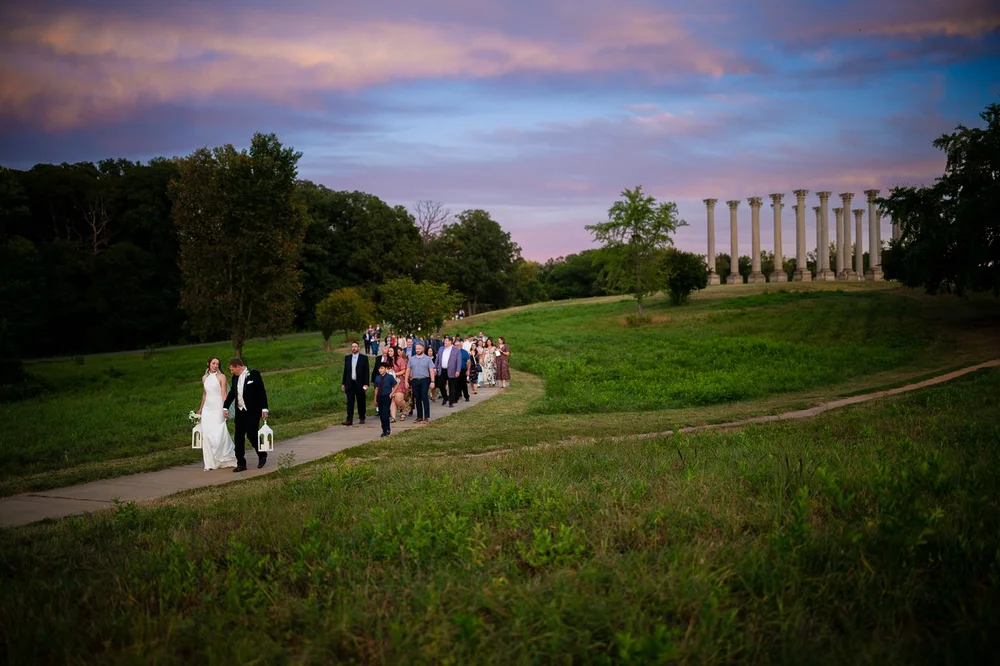 Wedding procession at sunset beside the Capitol Columns during a National Arboretum ceremony