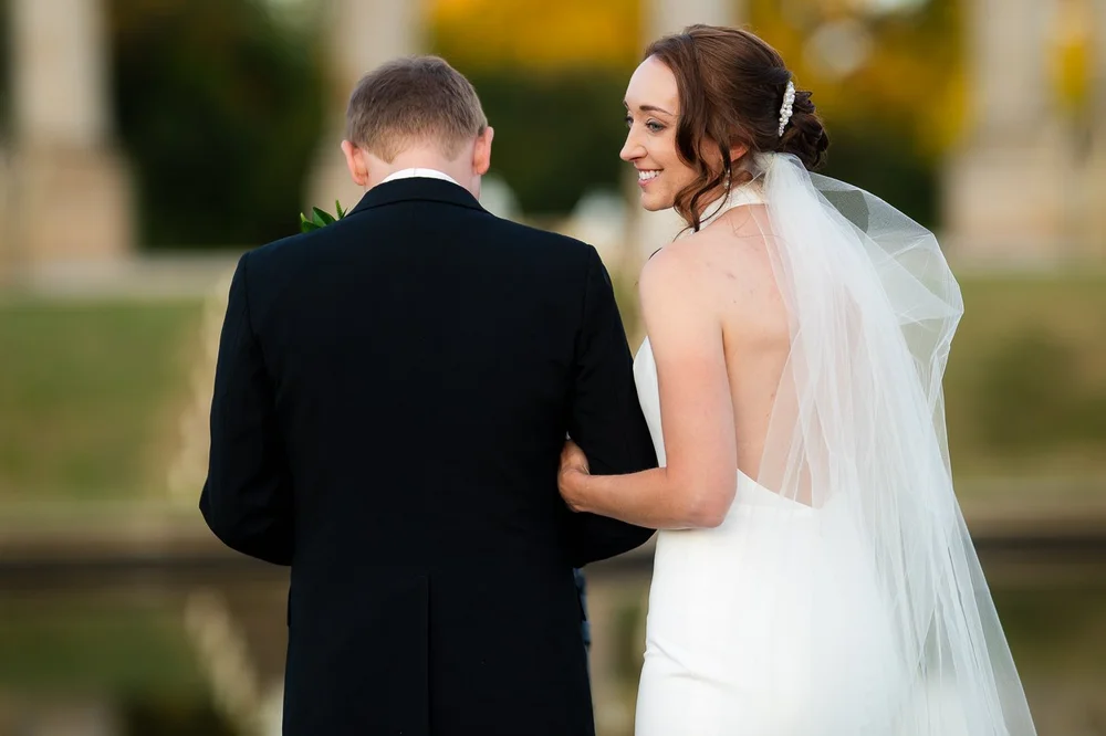 Bride looking back at groom during wedding portraits at the National Arboretum in Washington DC