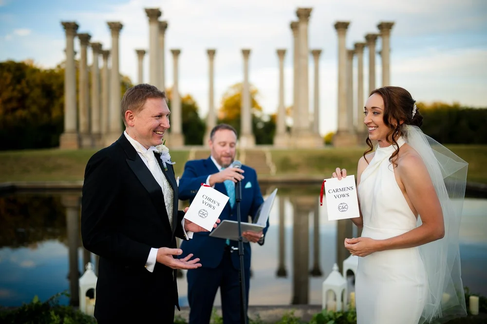 Bride and groom exchanging vows during an outdoor ceremony at the Capitol Columns
