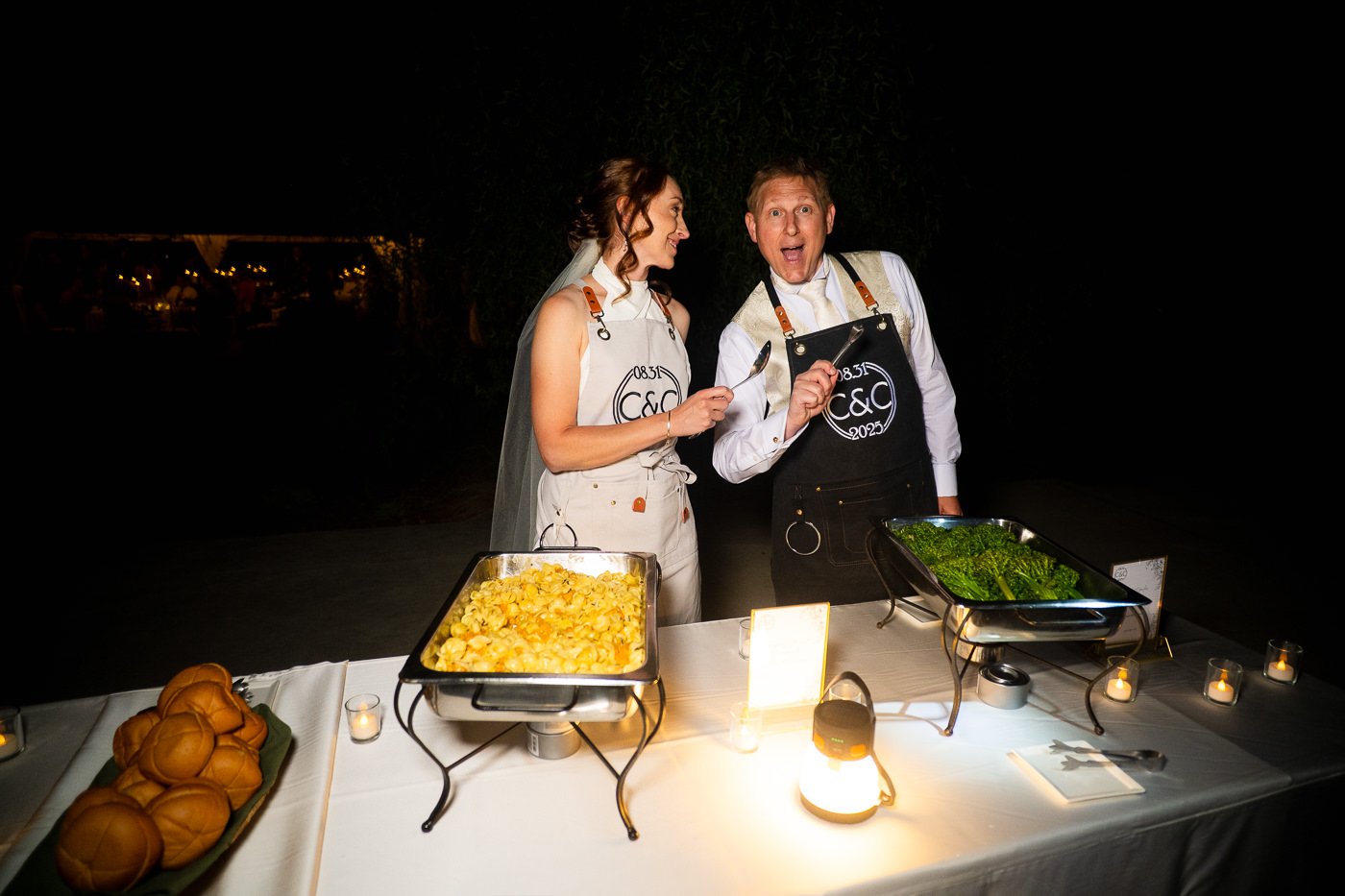 bride-groom-serving-food-wedding-reception-custom-aprons-mantas-kubilinskas.jpg