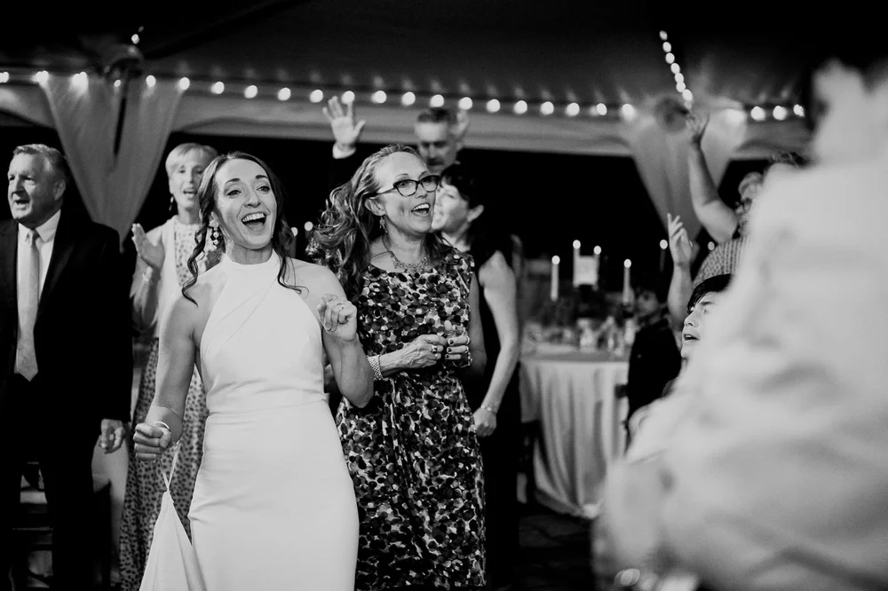 Bride celebrating with wedding guests during a joyful National Arboretum reception