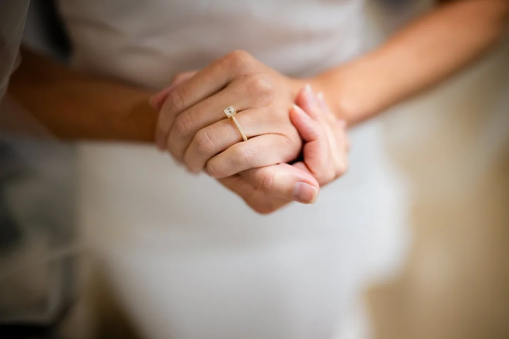 Close-up of the bride's engagement ring and wedding band on her wedding day