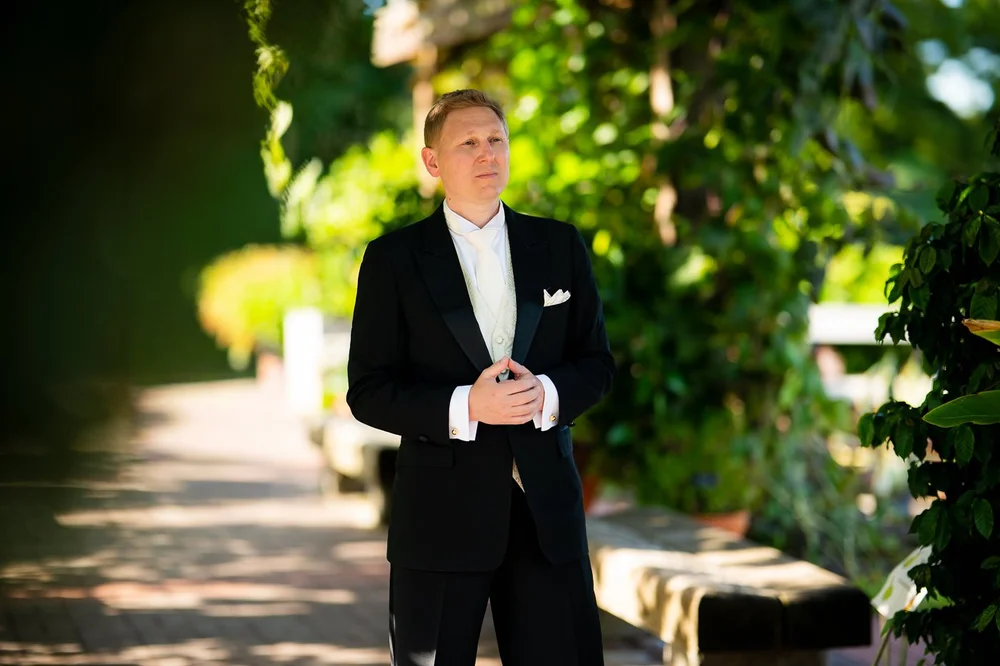 Outdoor garden portrait of groom at a National Arboretum wedding