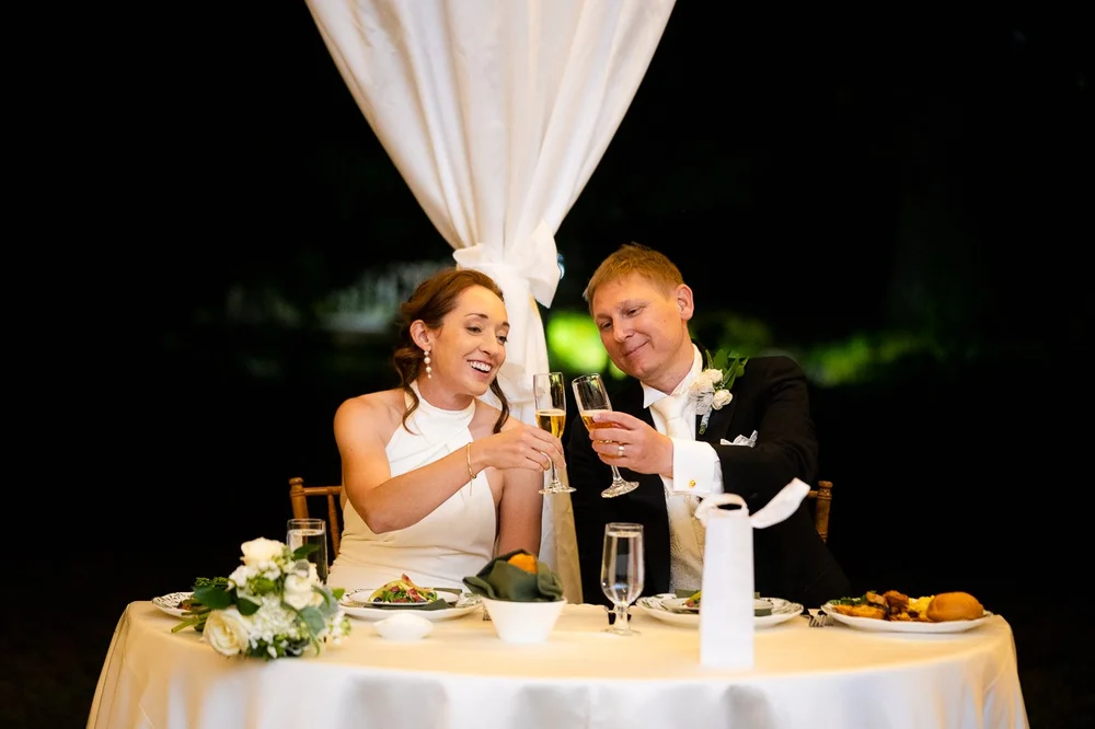 Bride and groom toasting at the head table during their National Arboretum wedding dinner