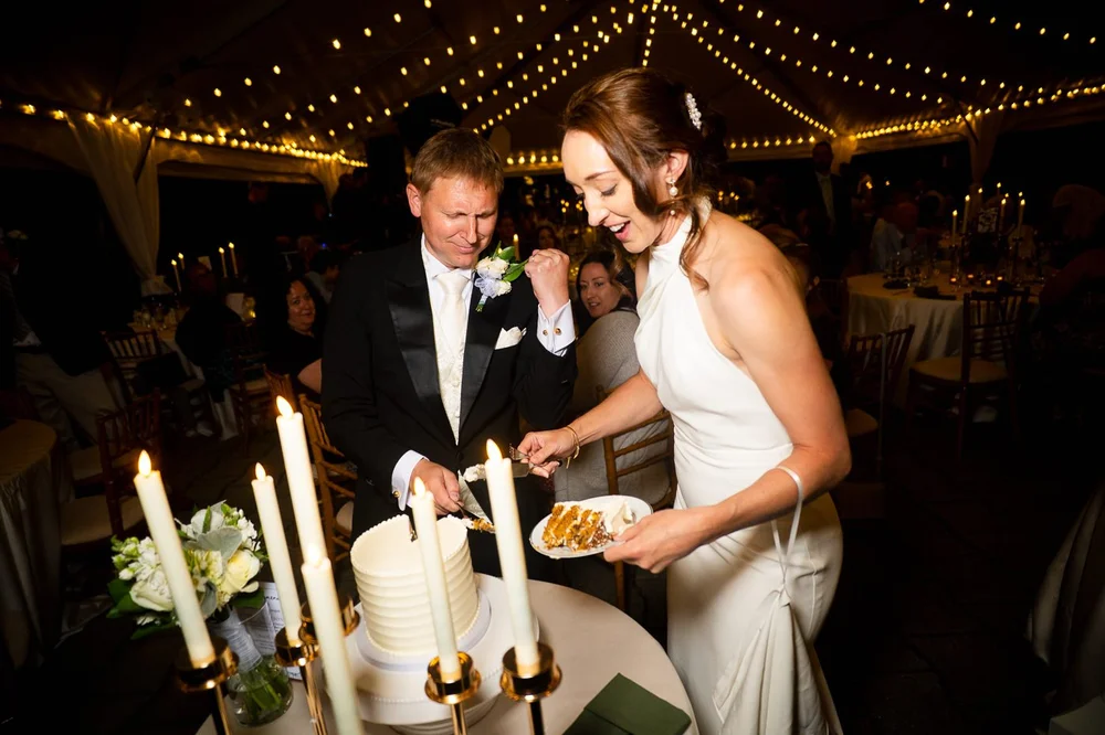 Bride and groom cutting their wedding cake during a National Arboretum reception