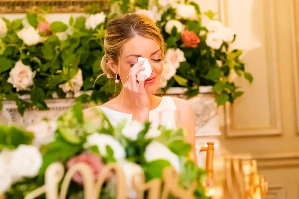 Emotional bride wiping away tears during heartfelt toasts at her Meridian House wedding