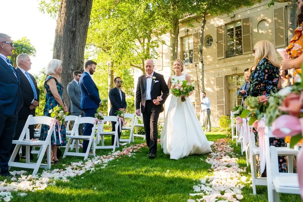 Father walks the bride down the outdoor aisle at the Meridian House wedding