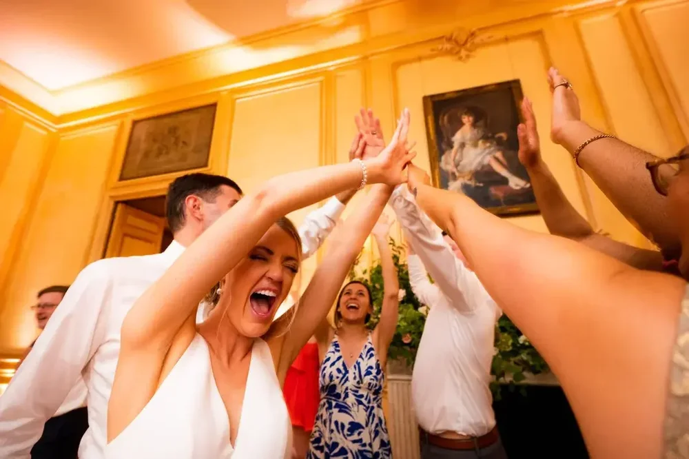 Bride giving high-fives to guests on the dance floor at her Meridian House wedding