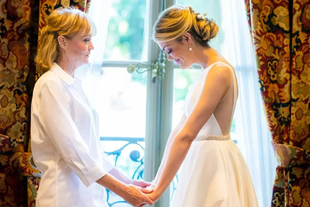 Bride and mother share an emotional moment by the window at Meridian House in Washington DC