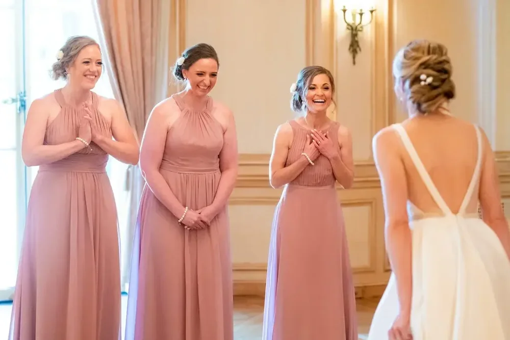 Bridesmaids react with joy seeing the bride for the first time at Meridian House in DC