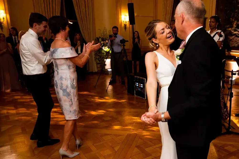 Bride laughing joyfully during the father-daughter dance at a Meridian House wedding