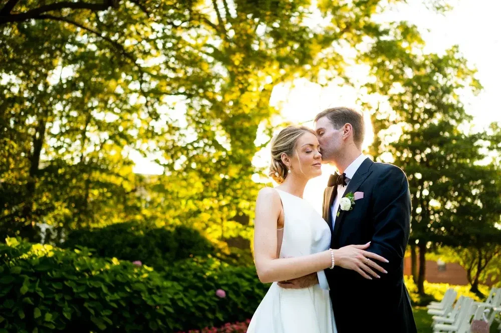 Bride and groom share a romantic moment in the golden hour garden at Meridian House