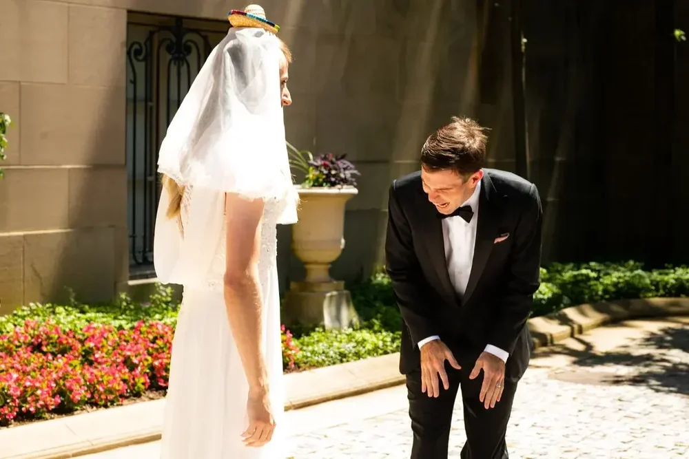 Groom bends over laughing with joy after seeing his bride at Meridian House wedding in DC