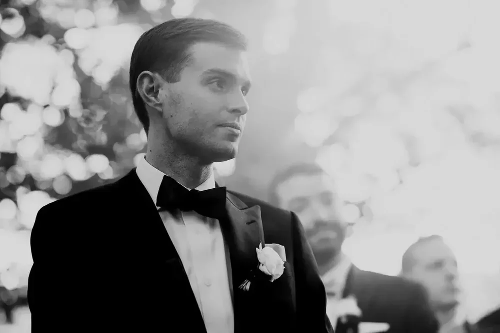 Groom portrait in black tie with boutonniere before the Meridian House ceremony